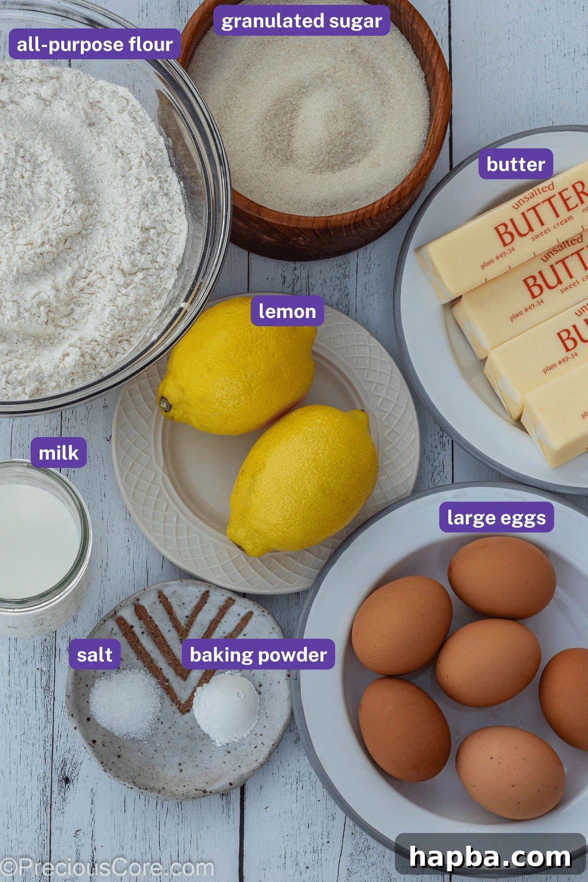 A collection of fresh ingredients laid out for making lemon pound cake, with labels indicating each item.