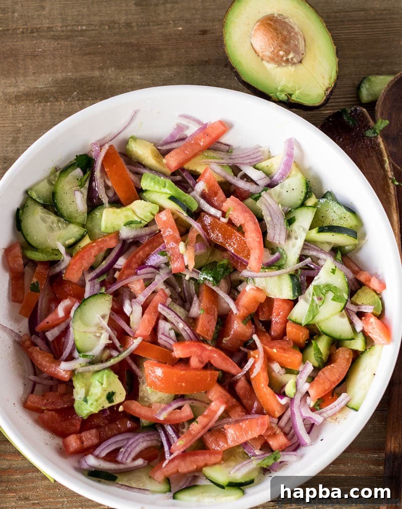 Close-up of Kachumbari salad, highlighting the avocado and cucumber additions for extra creaminess and crunch.