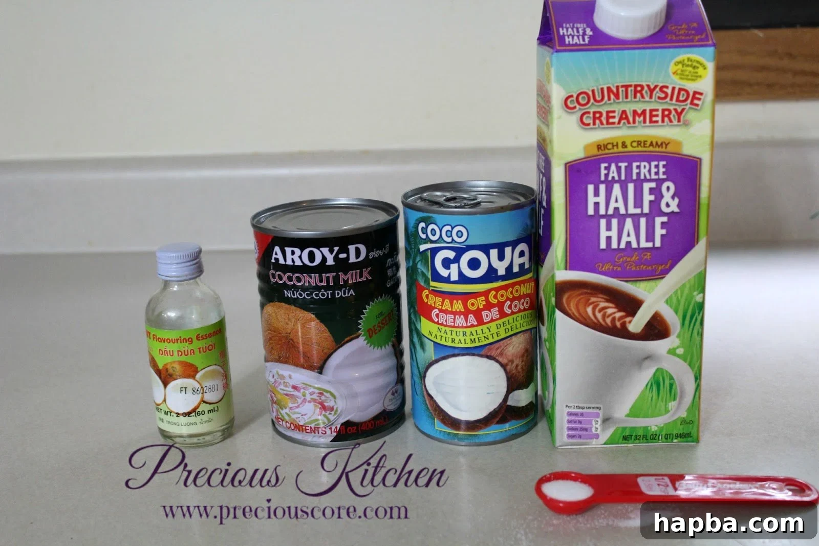 Ingredients for homemade coconut ice cream including cans of coconut milk and cream of coconut
