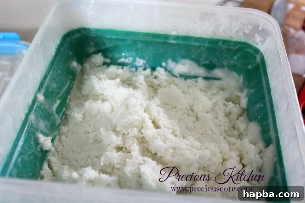Beating partially frozen coconut ice cream mixture in a bowl