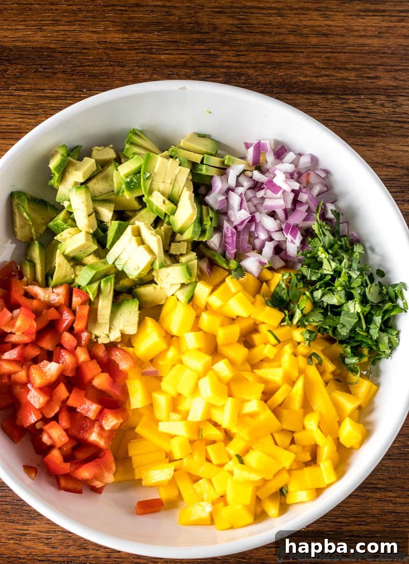 Chopped ingredients for Mango Avocado Salsa in a bowl before mixing.