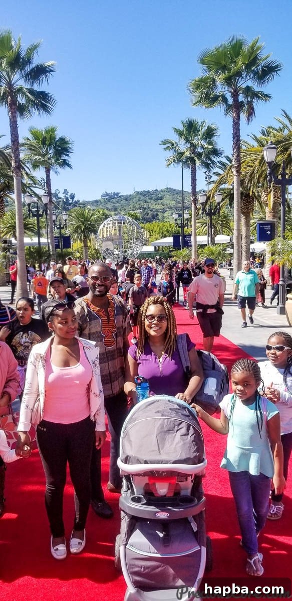 Our family walking the iconic red carpet entrance to Universal Studios Hollywood, ready for a day of movie magic and adventure.