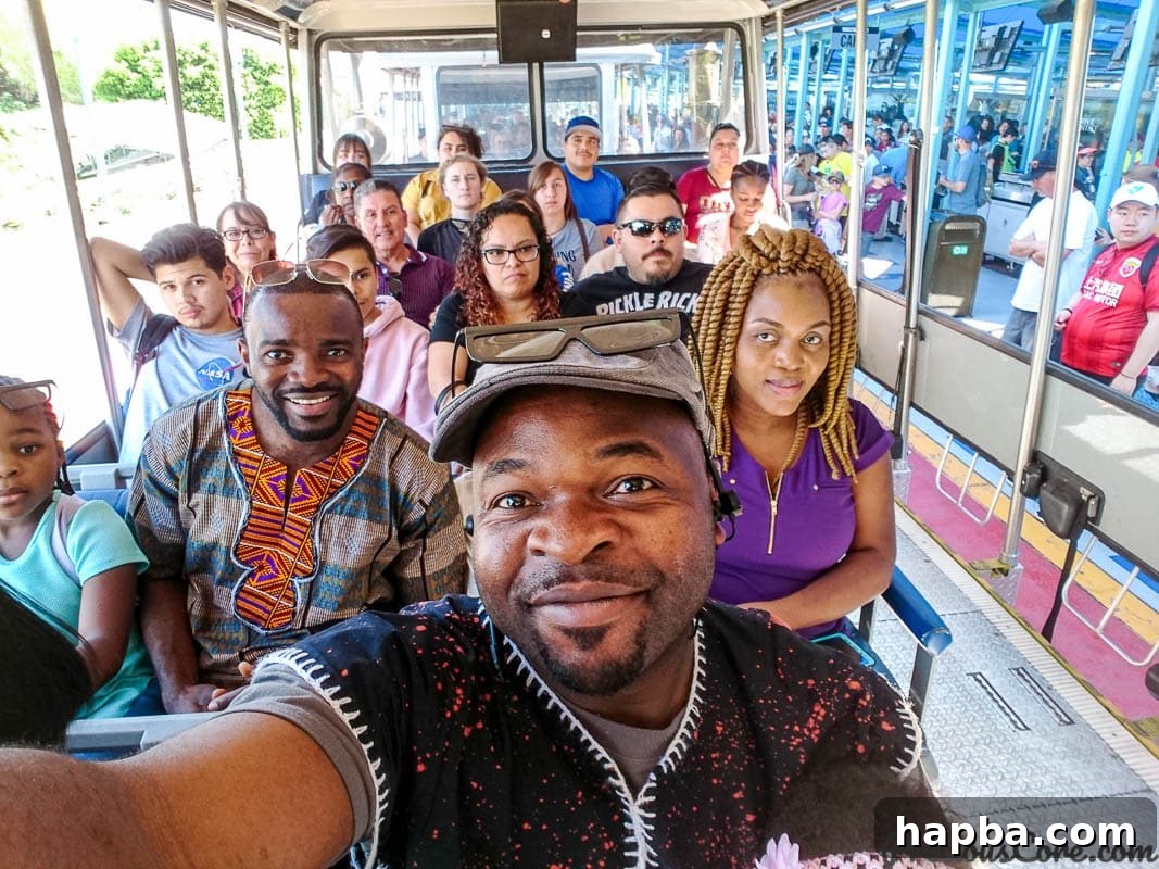 Visitors comfortably seated on the Studio Tour tram, ready to explore the working film sets and backlots of Universal Studios Hollywood.