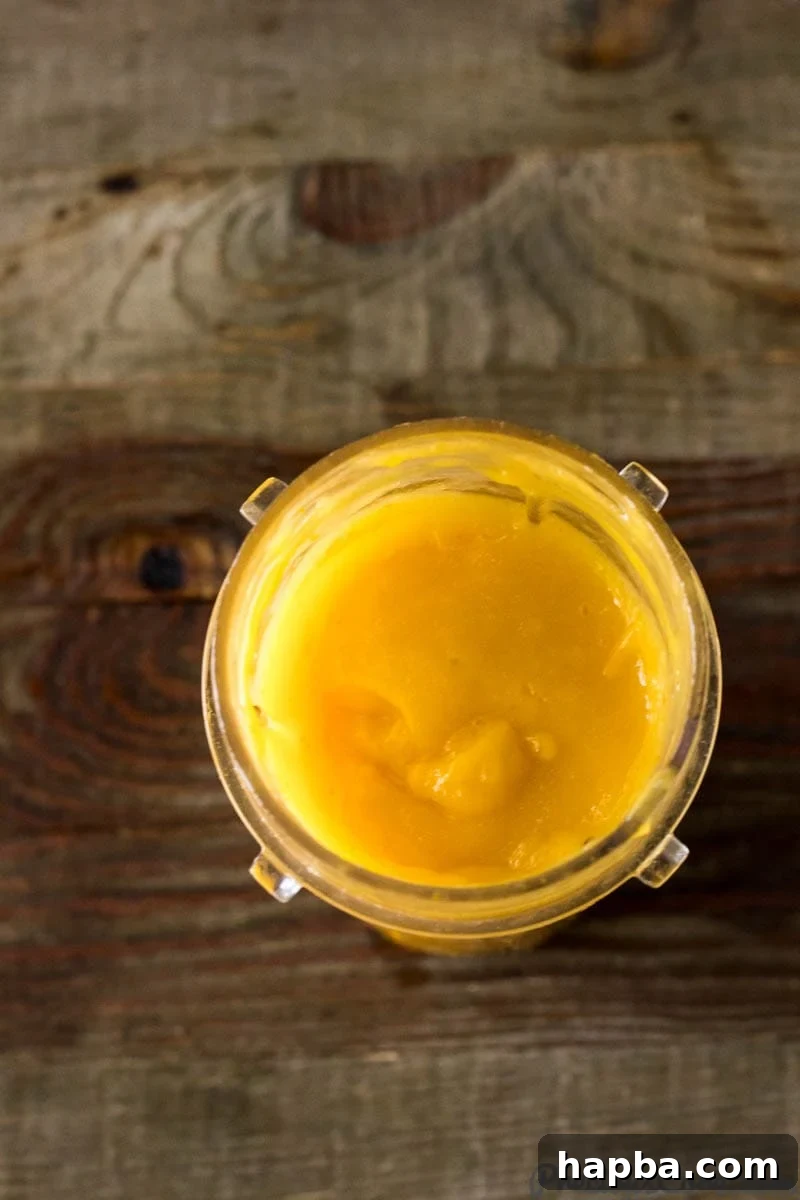 Golden Mango Bliss 5 Smooth and vibrant mango puree in a small blender jar, ready for assembly