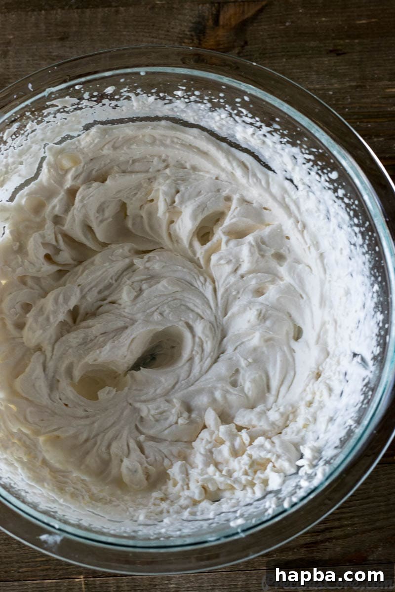 Golden Mango Bliss 6 Fluffy, homemade whipped cream with stiff peaks in a mixing bowl