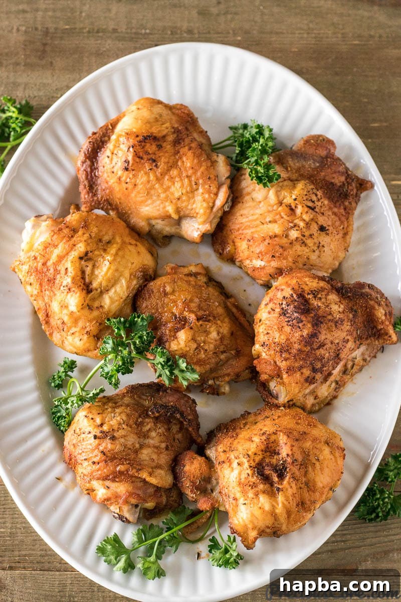 Crispy baked chicken thighs arranged neatly on a serving tray, ready to be enjoyed.