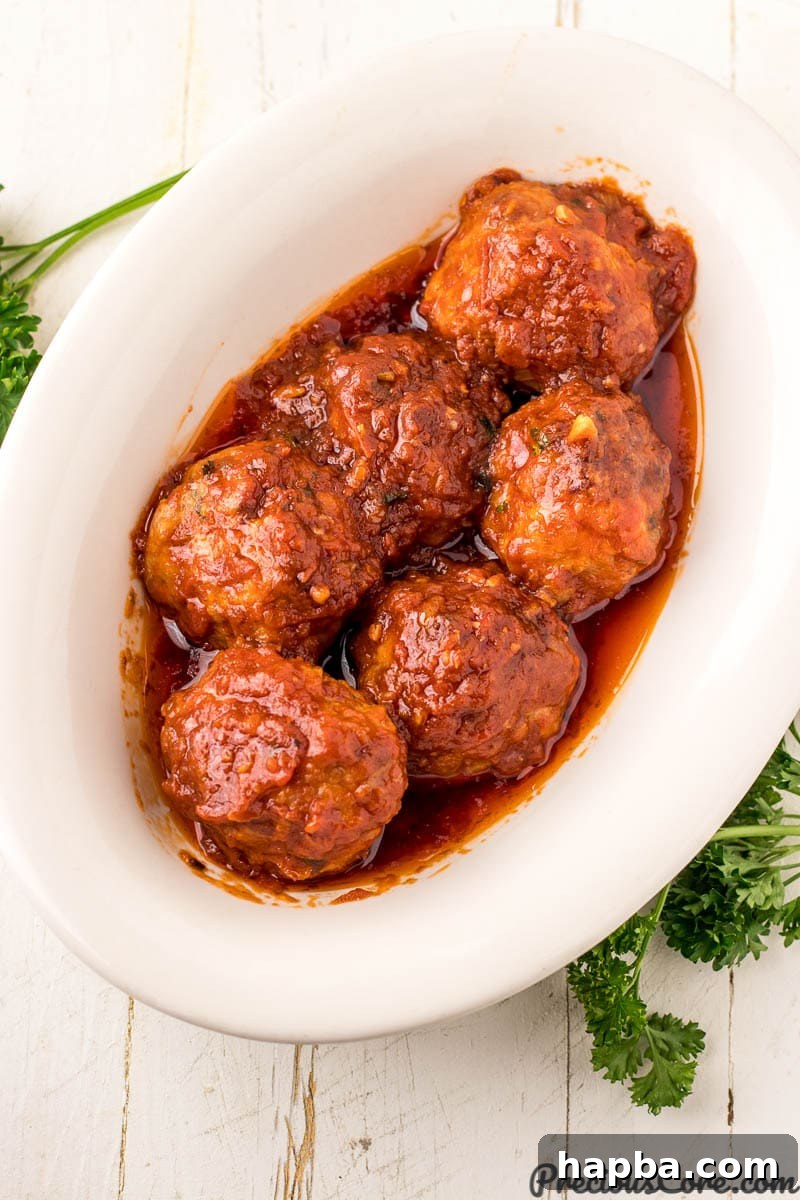 Chicken meatballs with luscious tomato sauce in a serving bowl.