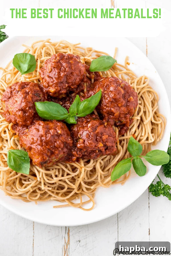 Picture of meatballs on spaghetti, garnished.