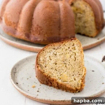 Slice of plantain cake on speckled plate