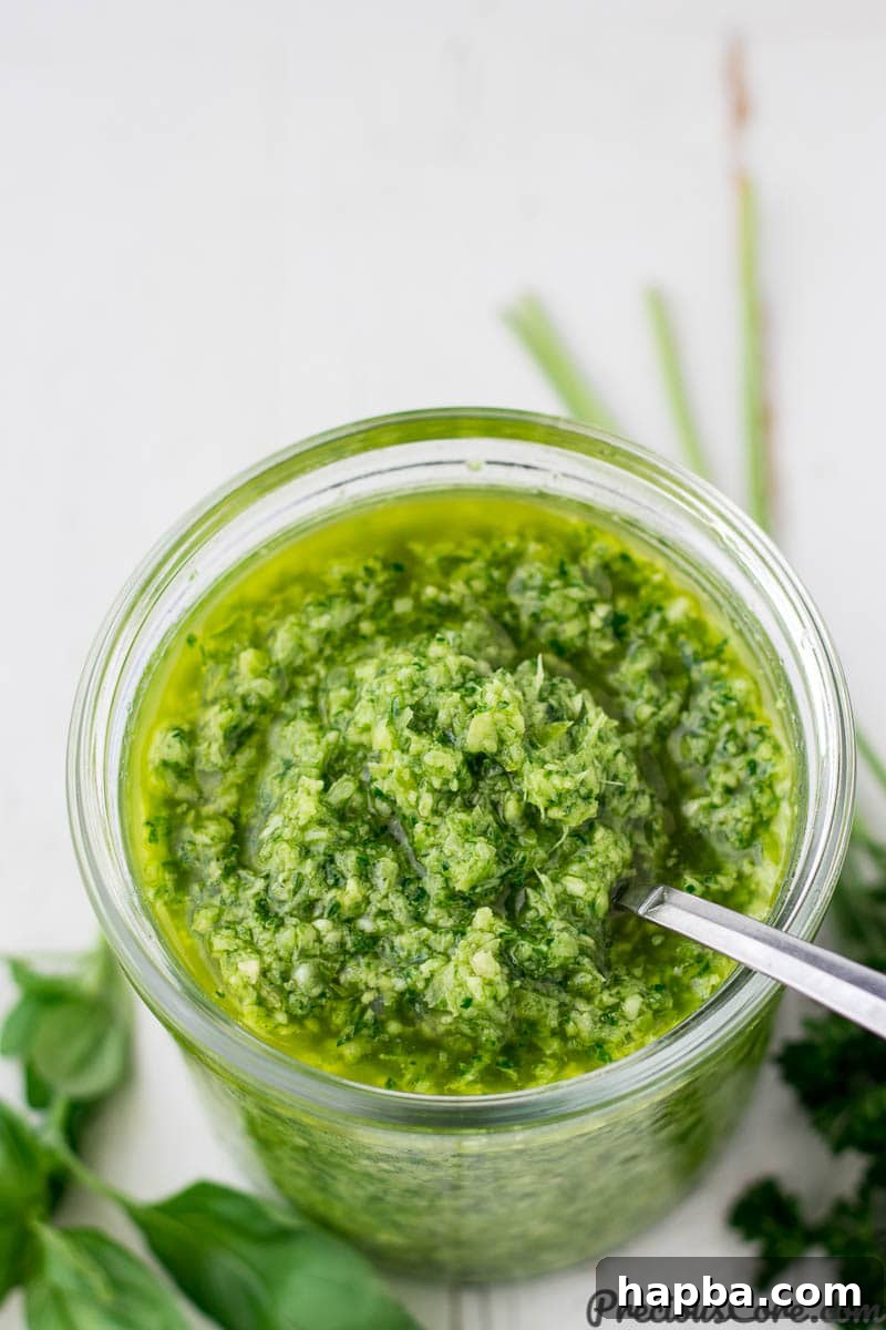 Vibrant Homemade Green Seasoning 2 A glass jar filled with vibrant green seasoning, ready to infuse flavor into any dish.