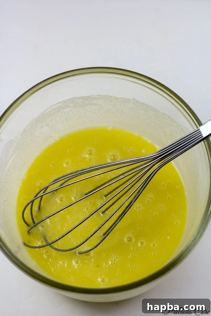 Beaten eggs, sugar, and milk mixture for the doughnut batter.