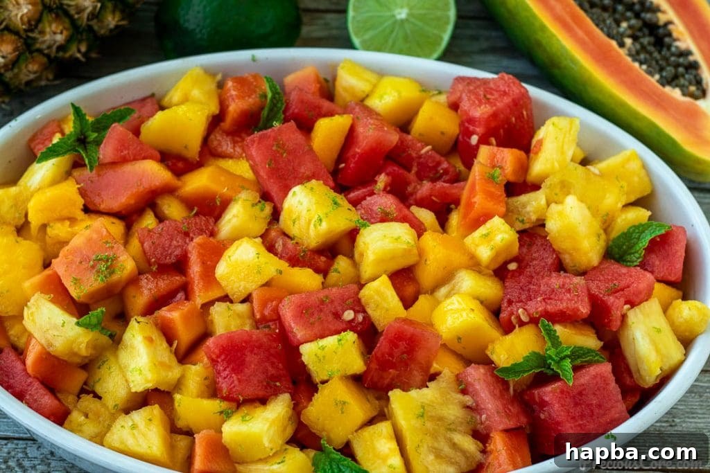 Landscape view of a colorful tropical fruit salad in a large serving bowl.