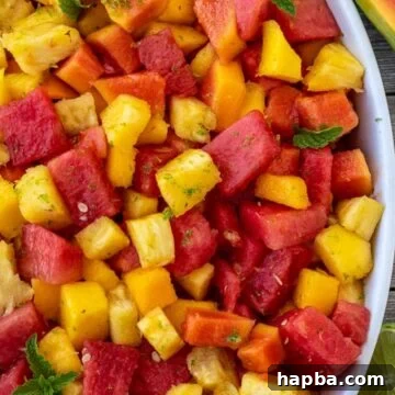 Tropical fruit salad in a serving bowl.