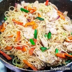 Stir fry with spaghetti and chicken in a pan