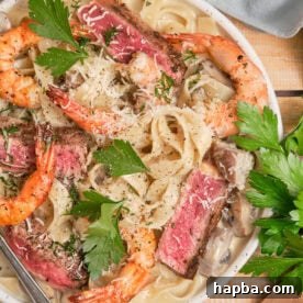 Creamy pasta topped with juicy steak and shrimp.