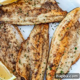 Pan Seared Sea Bass filets on a white plate.