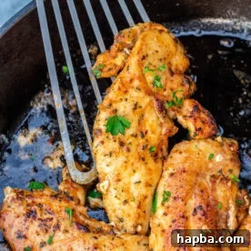 Spatula holding a cooked chicken tenderloin.