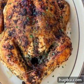 Whole herb roasted chicken on a platter