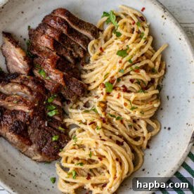 Steak and Pasta with homemade garlic cream sauce.