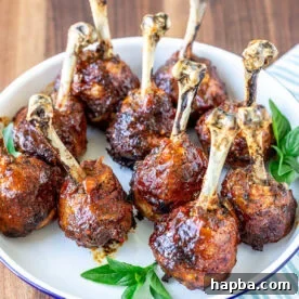 Plate of baked and glazed chicken lollipops.