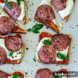 Pizza toast garnished with fresh basil.