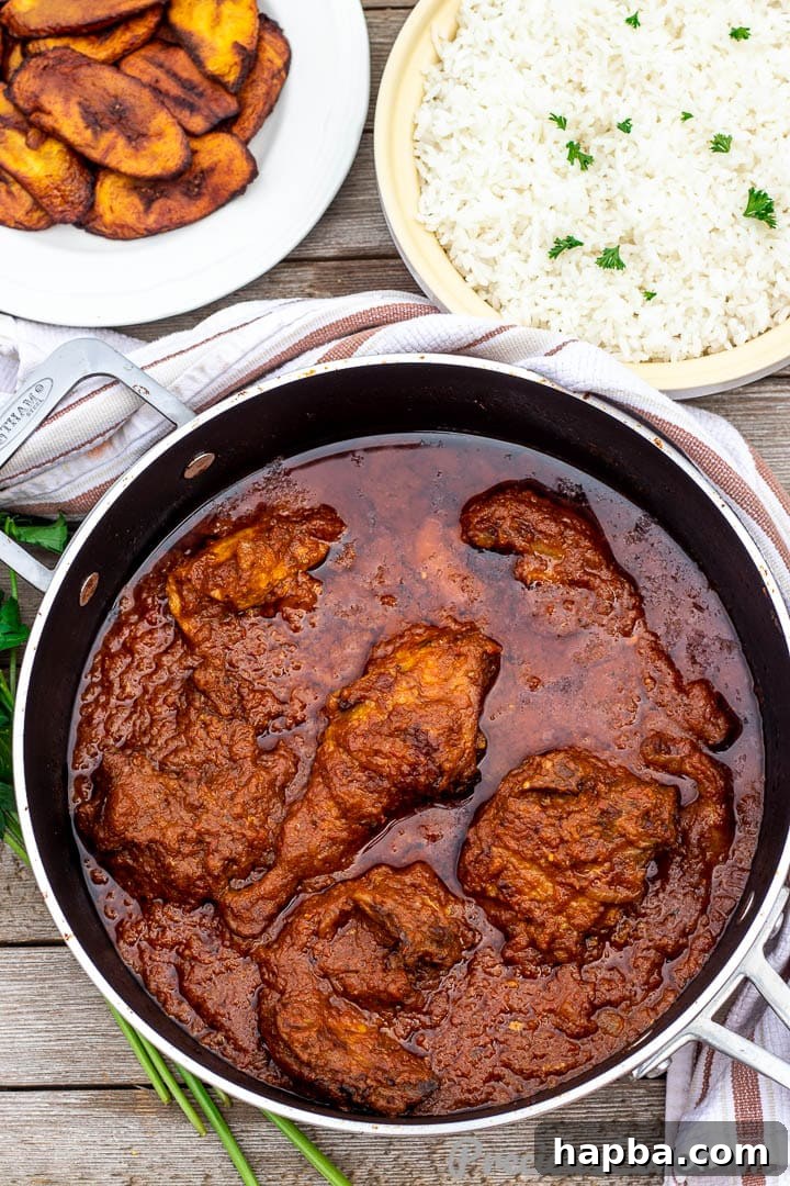 Three bowls showing a complete meal: African tomato chicken stew, fluffy white rice, and sweet fried plantains.