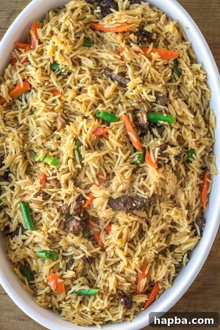 Savory Beef Fried Rice served in an elegant oval bowl, garnished and ready to enjoy.