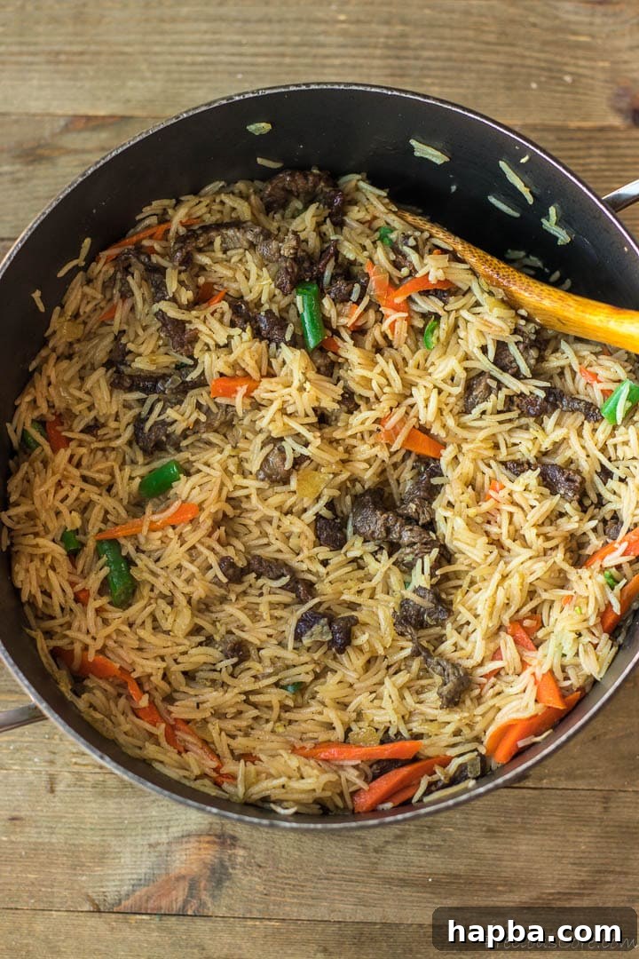 Delicious Beef Fried Rice cooking in a single pot, showing the steam and vibrant colors.
